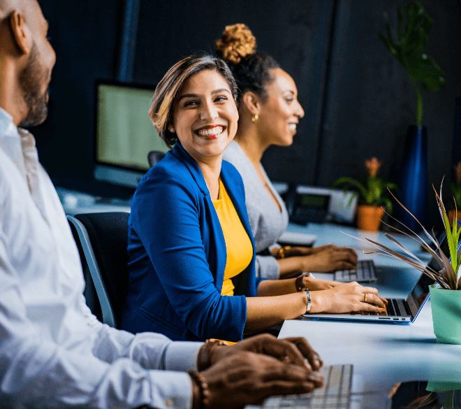 A leader smiling during a conversation with colleagues